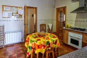 a kitchen with a table with a colorful table cloth at Casa Rural Mi Campo in Fenazar