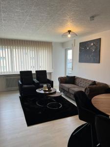 a living room with a couch and a table at FMA Ferienwohnung Heubach in Heubach