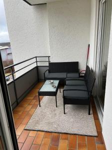 a balcony with a couch and a coffee table at FMA Ferienwohnung Heubach in Heubach