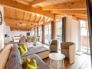 a living room with a couch and a table at Luxury penthouse with Balcony Ski Storage Carport Lift in Brixen im Thale