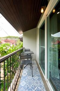 a patio with a table on a balcony at Teera villa chiang mai ทีร่าวิลล่าเชียงใหม่ in Chiang Mai