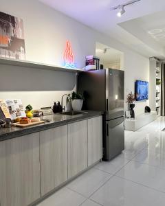 uma cozinha com um frigorífico de aço inoxidável em Fuzzi - Downtown modern 1BR near BuiVien walking street SOHO em Ho Chi Minh