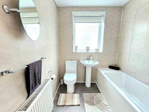 a bathroom with a sink and a toilet and a bath tub at Charming 3-Bed Oasis-free parking in Glasgow