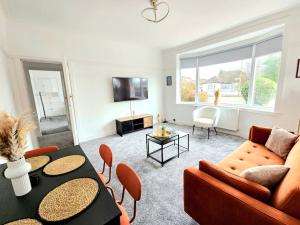 a living room with a couch and a table at Charming 3-Bed Oasis-free parking in Glasgow