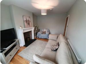 a living room with a couch and a television at York huntington Holiday let in York