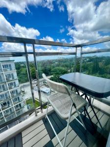 a table and chairs on the balcony of a building at SMDC Wind Tagaytay in Tagaytay