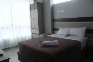 a bedroom with a bed with a towel on it at ¡Departamento Puñuy Wasi! in Cusco