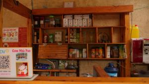 a shelf in a room filled with lots of spices at Homestay Nhà Pao in Loung Kam