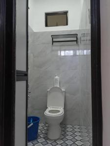 a bathroom with a white toilet in a stall at KZ Roomstay in Kuala Terengganu