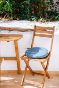 una almohada azul sentada en una silla de madera en Sibylla Studio Deluxe, en Kalymnos