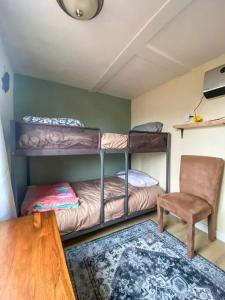 a room with two bunk beds and a chair at 2 bed 1 bath cottage home in Price