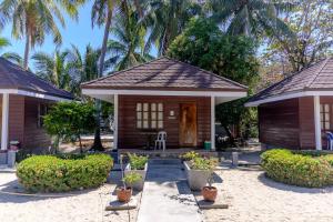 a small house with trees in the background at D' Elmer's Resort and Convention Hotel in Dinadiwan