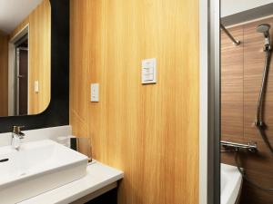 a bathroom with a sink and a mirror at MIMARU TOKYO GINZA EAST in Tokyo