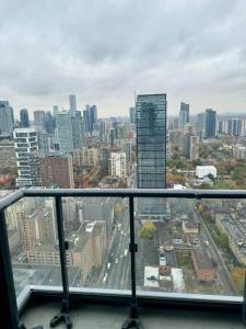 a view of a city skyline from a window at Cozy Condo Near EatonCentre Mall in Toronto