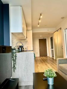 a kitchen with a counter and a table in a room at Cozy Condo Near EatonCentre Mall in Toronto