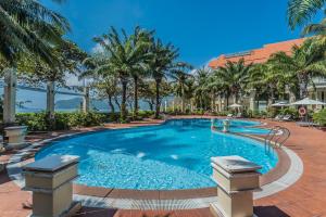a pool at a resort with palm trees at Sài Gòn Côn Đảo Resort in Con Dao
