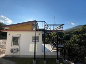 a house with a spiral staircase in front of it at Lamtam Maesa Resort ลำธารแม่สา รีสอร์ท in Mae Rim