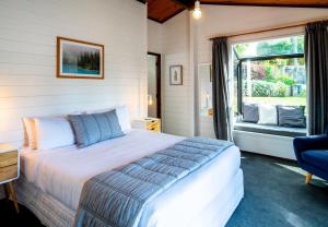 a bedroom with a large bed and a window at Aura @ Home in Rotorua