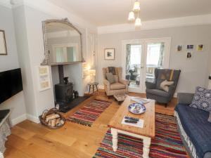 a living room with a couch and a table at Glenside in Far Sawrey