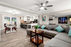 a living room with a couch and a table at Home with pool and games in central San Antonio in San Antonio