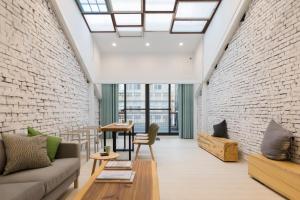 a living room with a couch and a brick wall at Meander 1948 in Taipei