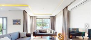 a living room with a couch and a chair at Villa Denizim in Kyrenia