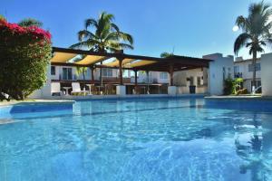 a large swimming pool in front of a building at Casa Lidia in Las Juntas