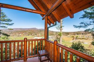 a view from the deck of a cabin with a bench at Mountain Creek Lodge in Pigeon Forge