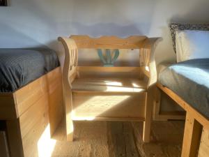 a bed and a night stand next to a bed and a table at Nature Lodge Csesztve in Csesztve
