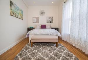 a bedroom with a bed and a rug at Modern Townhome,boston Vacation,2 Bath,pkg,deck in Brookline