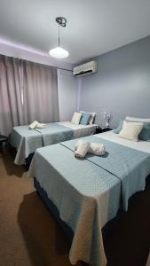 מיטה או מיטות בחדר ב-Essencial Hotel & Spa