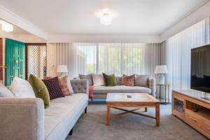 a living room with two couches and a coffee table at Arden Monte Vista in Rye