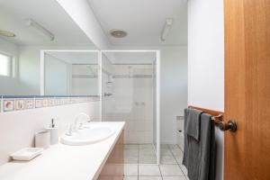 a white bathroom with a sink and a shower at Arden Monte Vista in Rye +24 photos