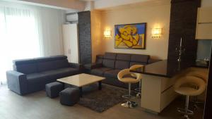 a living room with a couch and a table at Sophia 2 & Moonlight Apartaments in Mamaia