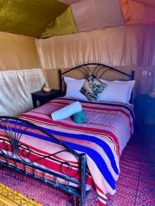 a bedroom with a bed in a tent at Overnight Desert Camp in Merzouga