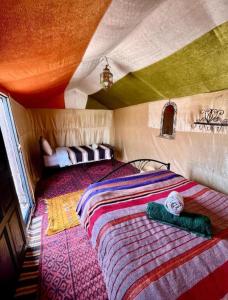 a bedroom with a large bed in a tent at Overnight Desert Camp in Merzouga