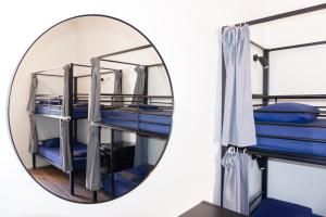 a mirror with two bunk beds in a room at Somewhere To Stay Backpackers in Brisbane