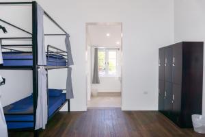 a room with two bunk beds and a closet at Somewhere To Stay Backpackers in Brisbane