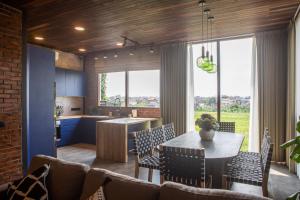 a kitchen and dining room with a table and chairs at Midgard house in Dalung