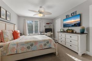 a bedroom with a bed and a dresser and a window at 114 Austin Ave, Unit 11 in Wildwood
