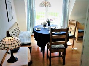 a dining room with a blue table and chairs at Lagoon on the Wadden See on Wangerooge in Wangerooge