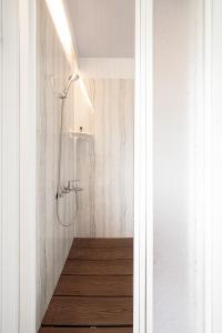 a bathroom with a shower with a wooden floor at Forest View Cottage 1 in Jiaoxi