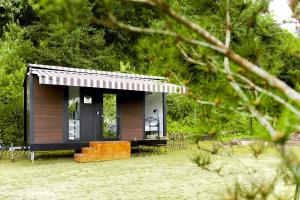 a small cabin in the middle of a yard at Forest View Cottage 2 in Jiaoxi