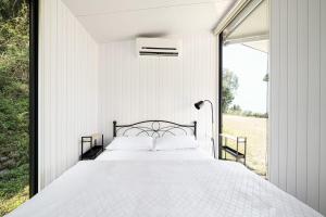 a bedroom with a large bed and a window at Forest View Cottage 2 in Jiaoxi