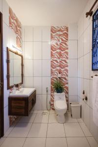 a bathroom with a toilet and a sink at Beachfront Bliss Apartment in Mombasa