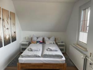 a bedroom with a bed with white sheets and pillows at Ferienhaus Rupnow Plau am See in Plau am See