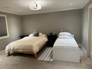 a bedroom with two beds and a window at Charming Modern Home Near Downtown and UBC in Vancouver