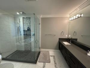 a bathroom with a glass shower and a sink at Charming Modern Home Near Downtown and UBC in Vancouver