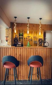 two bar stools in front of a bar at PS Boutique Hotel in Kathmandu