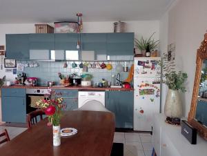 a kitchen with a table and a refrigerator at Appartement lumineux et confort ! in Pantin